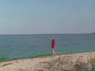 Verlegen naakt tiener op de strand